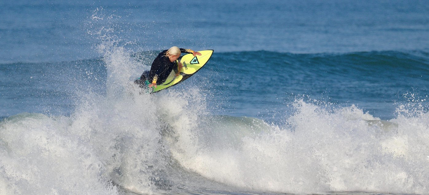 Surf Grom catching air on a left hander